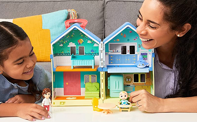 A Girl and a Woman Playing CoComelon Deluxe House Playset in the Living Room