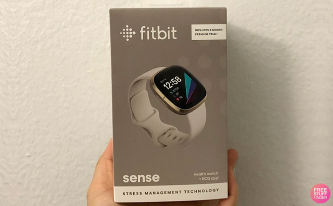 A Hand Holding Fitbit Sense Advanced Smartwatch in a Box