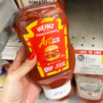 A Hand Holding Heinz Tomato Ketchup in Publix 1