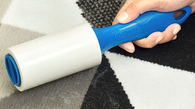 A Hand Holding PetLovers Extra Sticky Lint Roller For Pet Hair Removal
