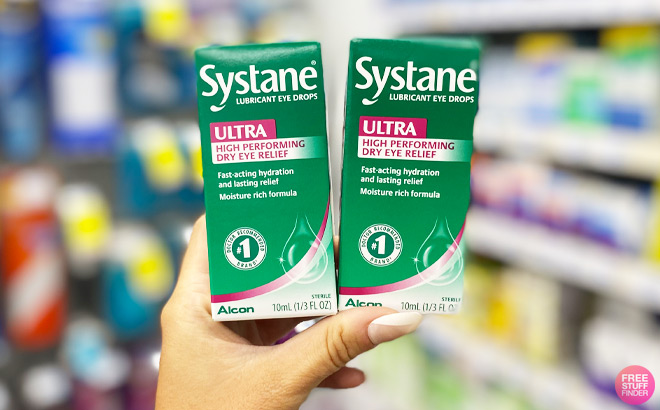 A Hand Holding Two Systane Ultra Eye Drops Packs