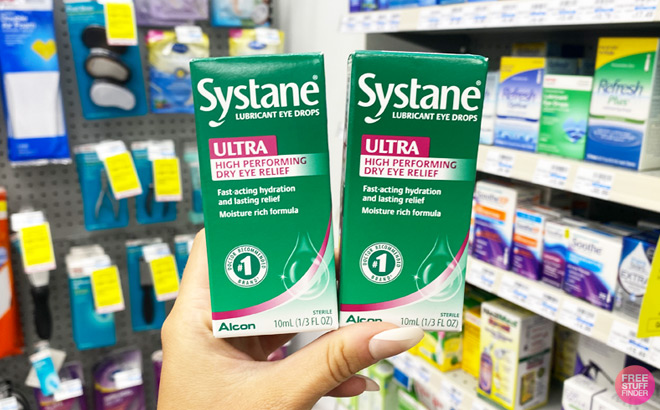 A Hand Holding Two Systane Ultra Lubricant Eye Drops Packs
