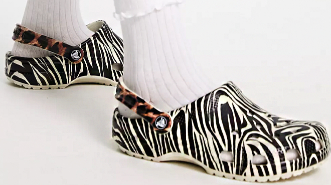 A Model Wearing Crocs Classic Animal Remix Clogs in Bone Multi Color