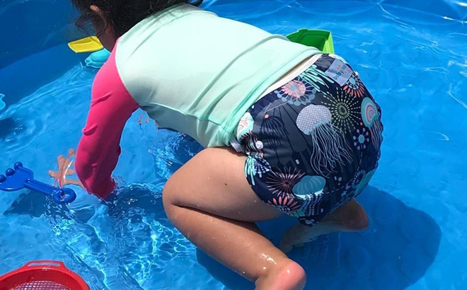A Toddler Playing in a Pool Wearing Babygoal Baby Swim Diaper