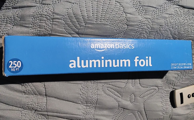 Amazon Basics Aluminum Foil 225 Square Feet on a Grey Bedspread