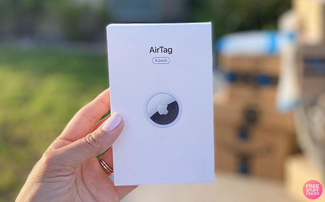 A Hand Holding a 4-Pack of Apple AirTags