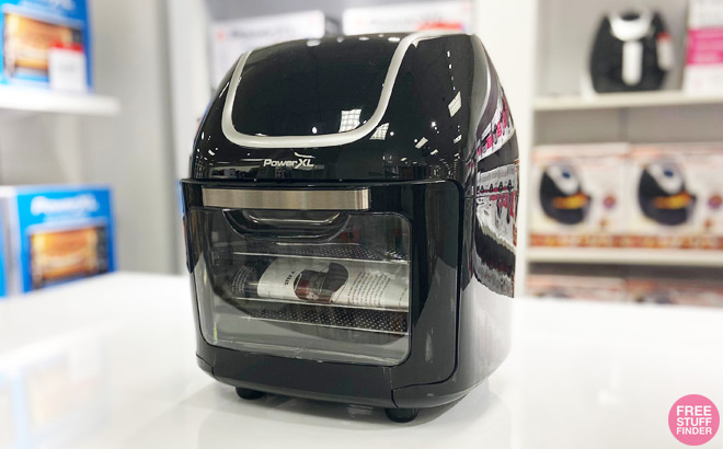 Black PowerXL 10 Quart Vortex Pro Air Fryer on a Store Countertop