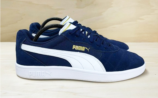 Blue Puma Astro Kick Sneakers on a Wooden Floor
