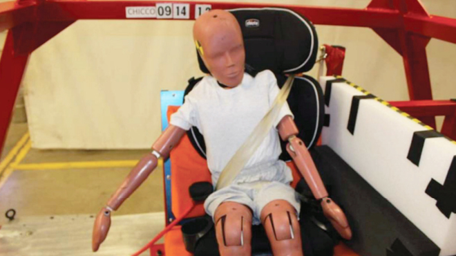 Chicco Settlement crash test dummy sitting on a booster seat