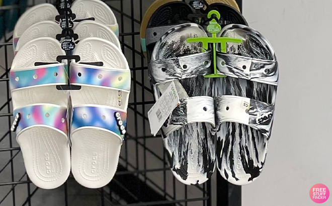 Crocs Classic Marbled Sandals in White and Black Color on a Hanger