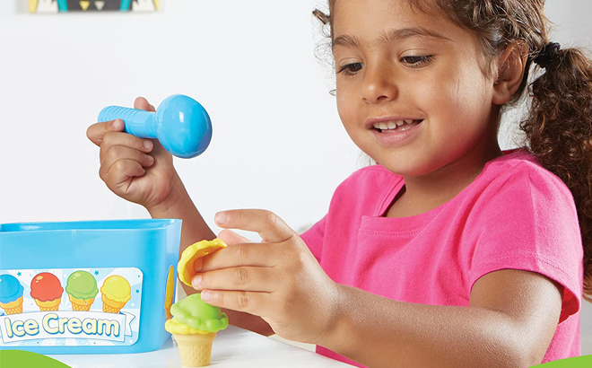 Girl Holding Smart Scoops Math Activity Set 55 Piece Girl Holding Smart Scoops Math Activity Set 55 Piece