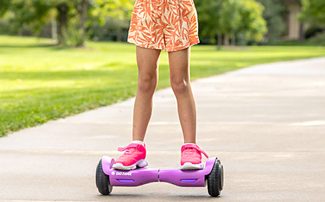 Girl Riding the Gotrax Lil Cub Kids Hoverboard in Purple Color