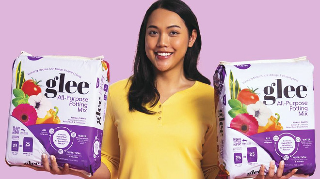 Woman holding two Glee All Purpose Potting Mix