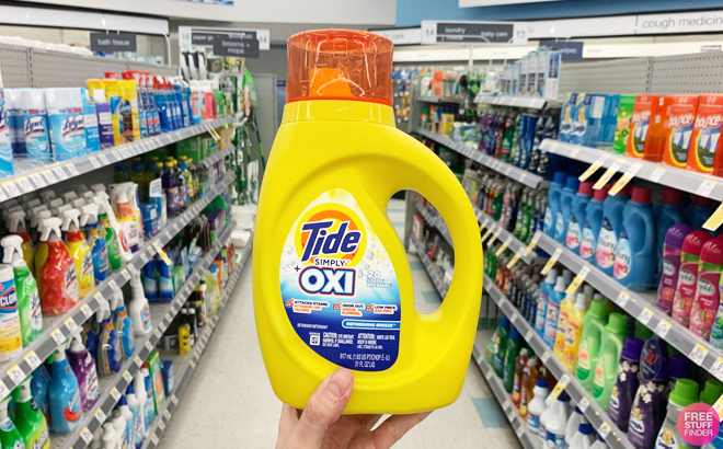 Hand Holding Tide Simply Oxi 20 Loads Inside Walgreens Store