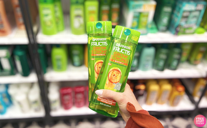 Hand Holding Two Garnier Fructis Shampoos at Target