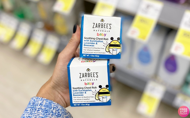Hand Holding Two Zarbees Baby Chest Rub at Walgreens