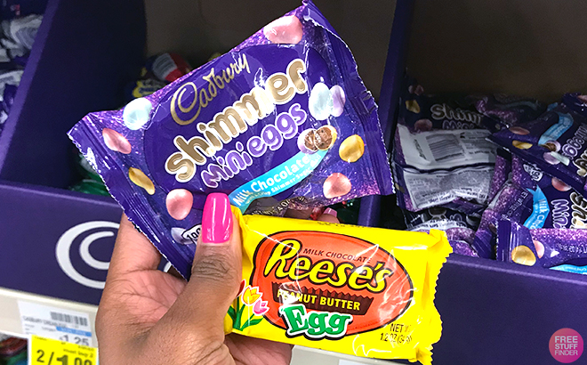 Hand holding Cadbury and Reeses Candies