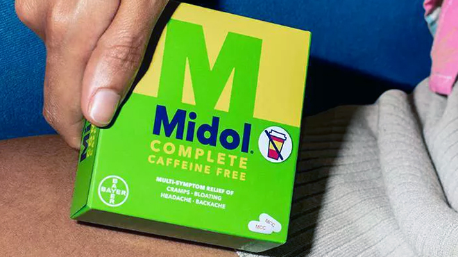 Hand holding Midol Complete Caffeine Free