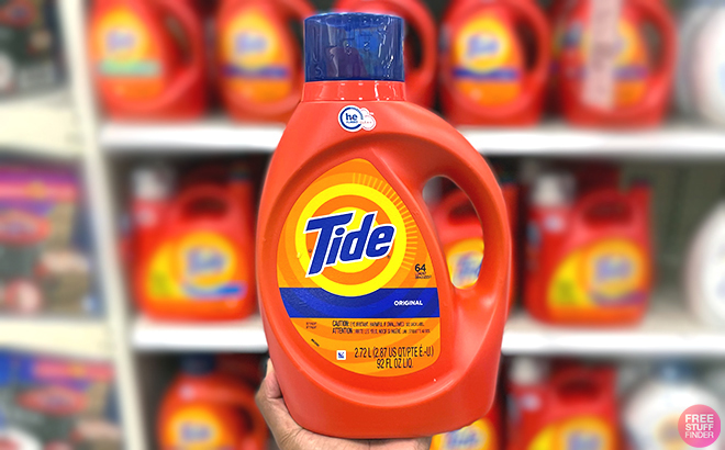 Hand holding Tide Liquid Laundry Detergent 64 Loads