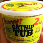 Hand holding Yeowww Catnip Tub 2 Ounce