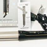 InfinitiPro by Conair Cool Air Curling Iron on a Table Next to the Instructions Manual 1