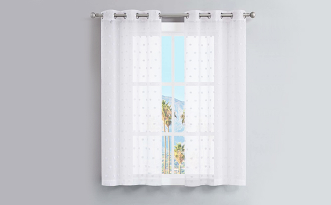 Juicy Couture White Evelyn Sheer Pom Pom Curtain Panel Set of 2 on a Gray Background