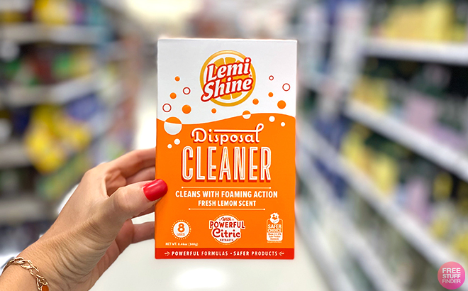 Hand holding Lemi Shine Disposal Cleaner