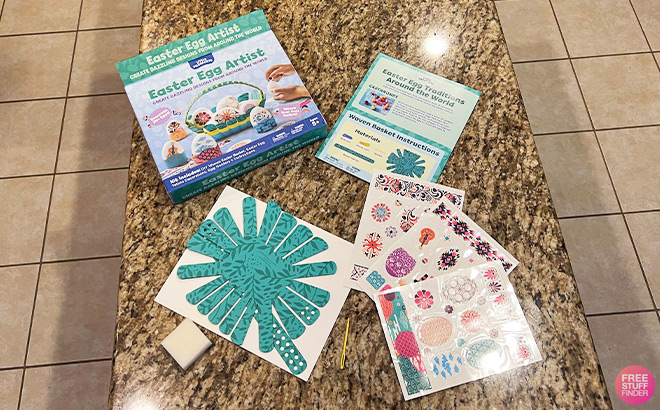 Little Passports Easter Egg Artist Kids Subscription Box Manuals on a Kitchen Countertop