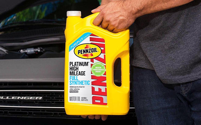 Man Holdin Pennzoil Platinum Full Sythetic High Mileage Motor Oil