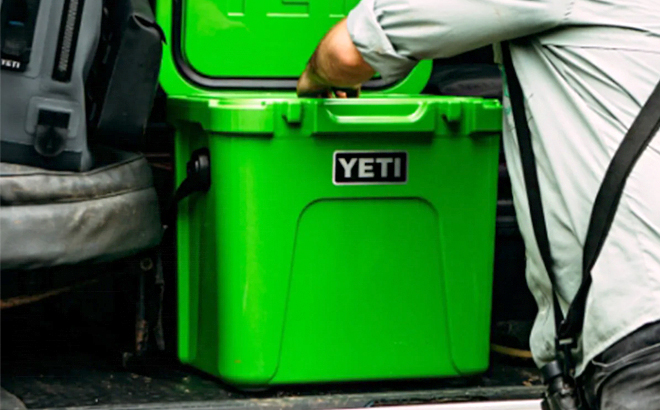 Man Stocking Up the YETI Roadie 24 Cooler in Canopy Green Color