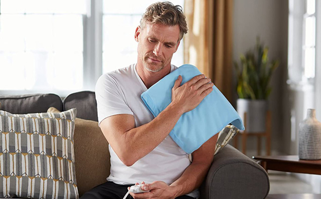 Man wearing Sunbeam Heating Pad for Back Neck and Shoulder Pain