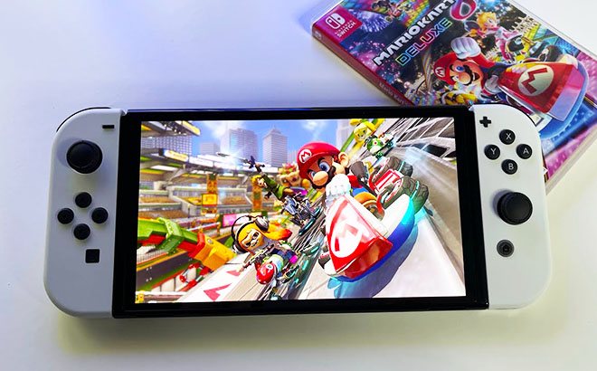 Mario Kart 8 Deluxe Nintendo Switch Game Being Played on a Switch with a Game Box Next to It
