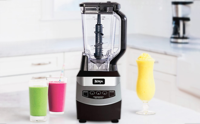 Ninja Professional Blender on a Marble Countertop with Three Smoothies in Different Flavors