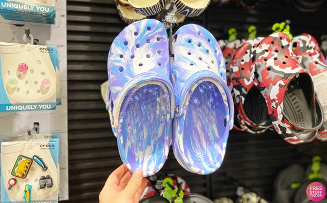 Person Holding Crocs Marbled Classic Clogs