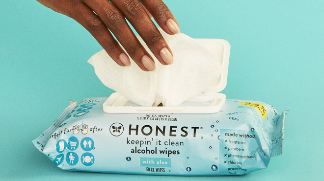 Pesons Hand Taking The Honest Company Sanitizing Alcohol Wipes Unscented 50 Count