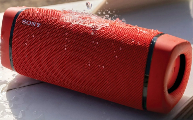 Sony Wireless Waterproof Bluetooth Portable Speaker in Red with Water Dripping on it