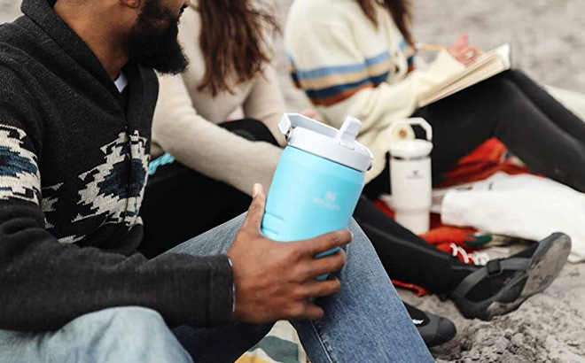 Man Holding the Stanley Iceflow Flip Straw Jug at the Beach Stanley Iceflow Flip Straw Jug
