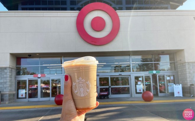 Woman's Hand Holding Starbucks Drink in Front of Target Store Bullseye Sign