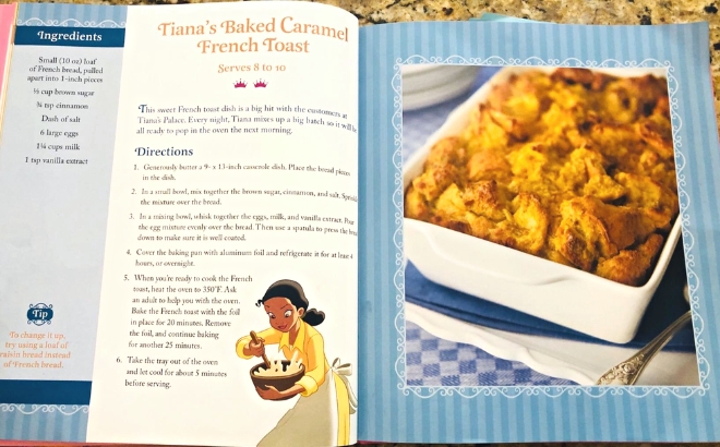 The Disney Princess Cookbook Open at Tianas Baked Caramel French Toast Recipe on a Marble Counter