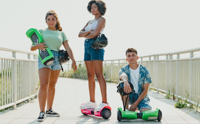 Three Teenagers with Their Hover 1 Rocket 2 0 Hoverboards in Pink and Green