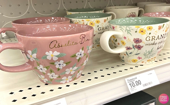 Threshold Abuelita Bonita Latte Mug on a Shelf at Target on the Left and the Grandmas Make Everything Better One on the Right