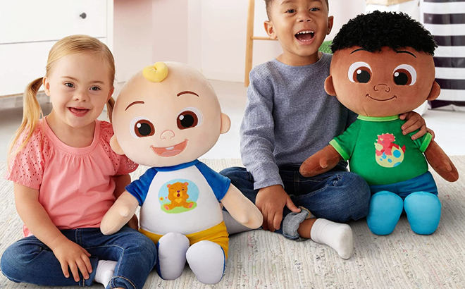 Two Kids Sitting on the Floor and Holding CoComelon 22 Inch Plush JJ and Cody