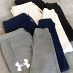 Under Armour Mens Rival Fleece Logo Joggers on a Bed