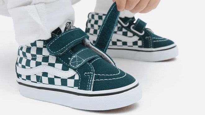 Kid Wearing VANS Sk8-Mid Reissue Checkerboard Skate Shoes