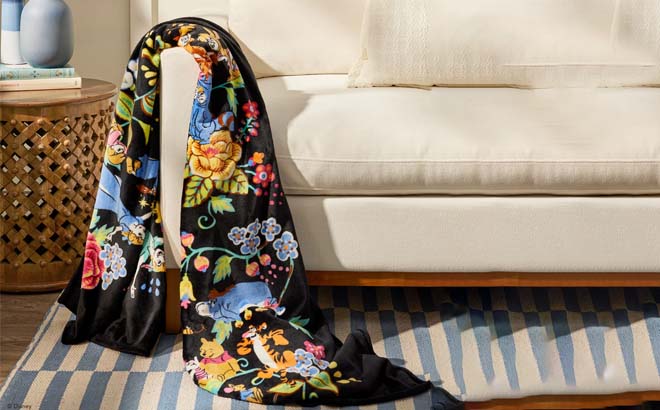 Vera Bradley x Disney Plush Throw Blanket hanging on Couch
