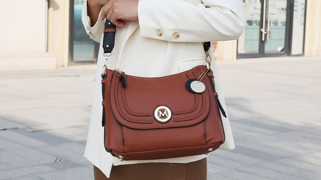 Woman Carrying MKF Collection Maggie Large Shoulder Bag in Cognac Color