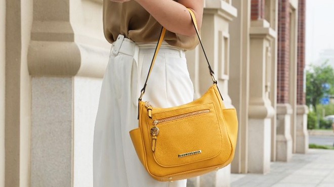 Woman Carrying MKF Womens Wally Handbag in Yellow Color