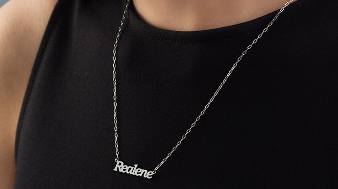Woman Wearing Zales Script Name Necklace in Stainless Steel with The Name Realene