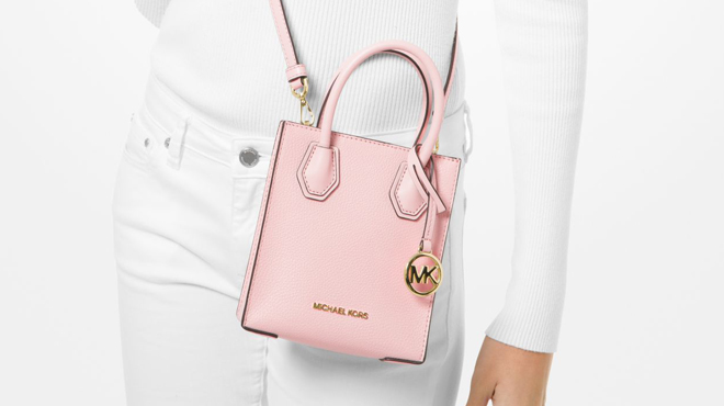 a Person Wearing Mercer Extra Small Pebbled Leather Crossbody Bag Pink Color