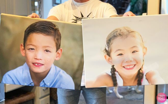 Man Holding Two Canvas Prints with Kids' Faces 